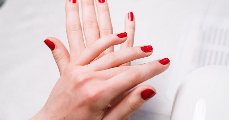Nail technician working on client